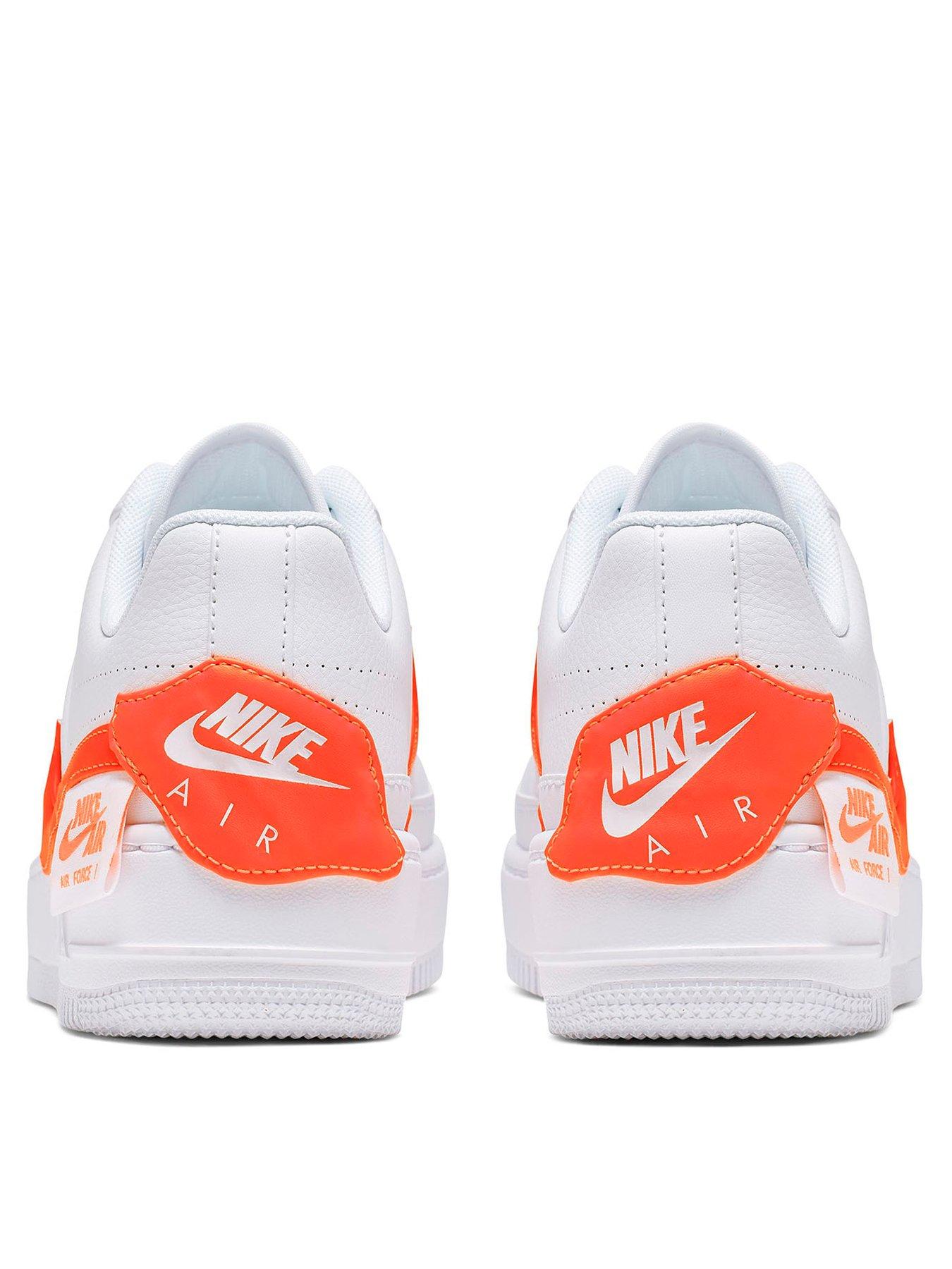 white nike trainers with orange tick