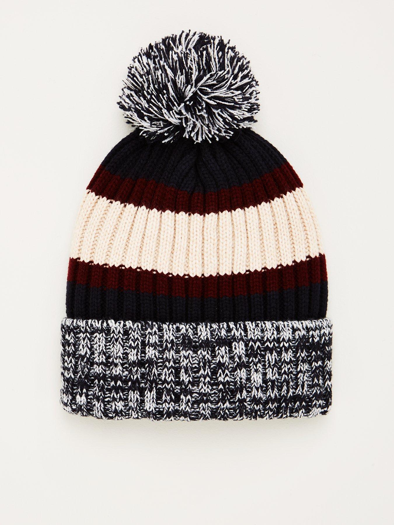 black hat with cream bobble