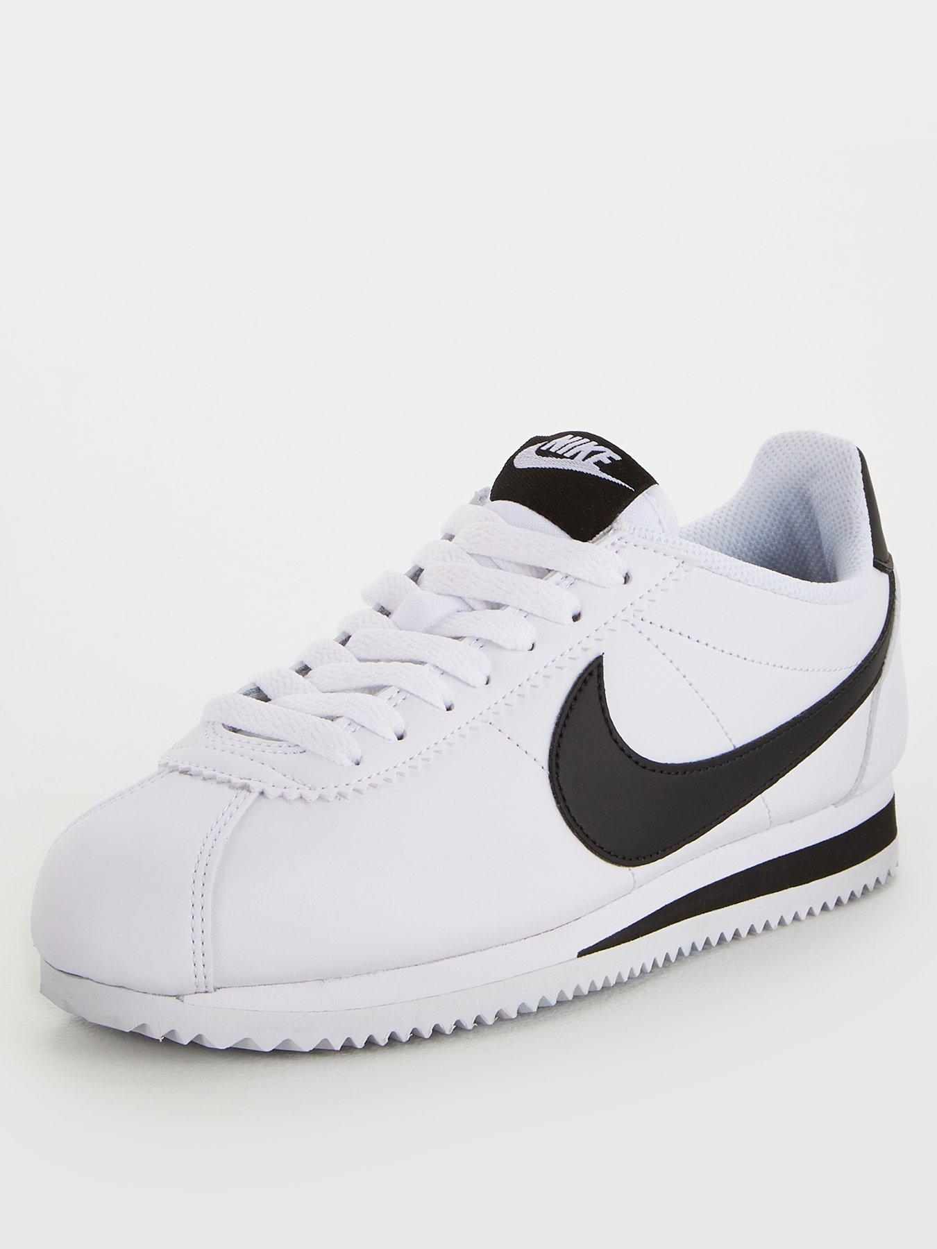 white nike runners with black tick